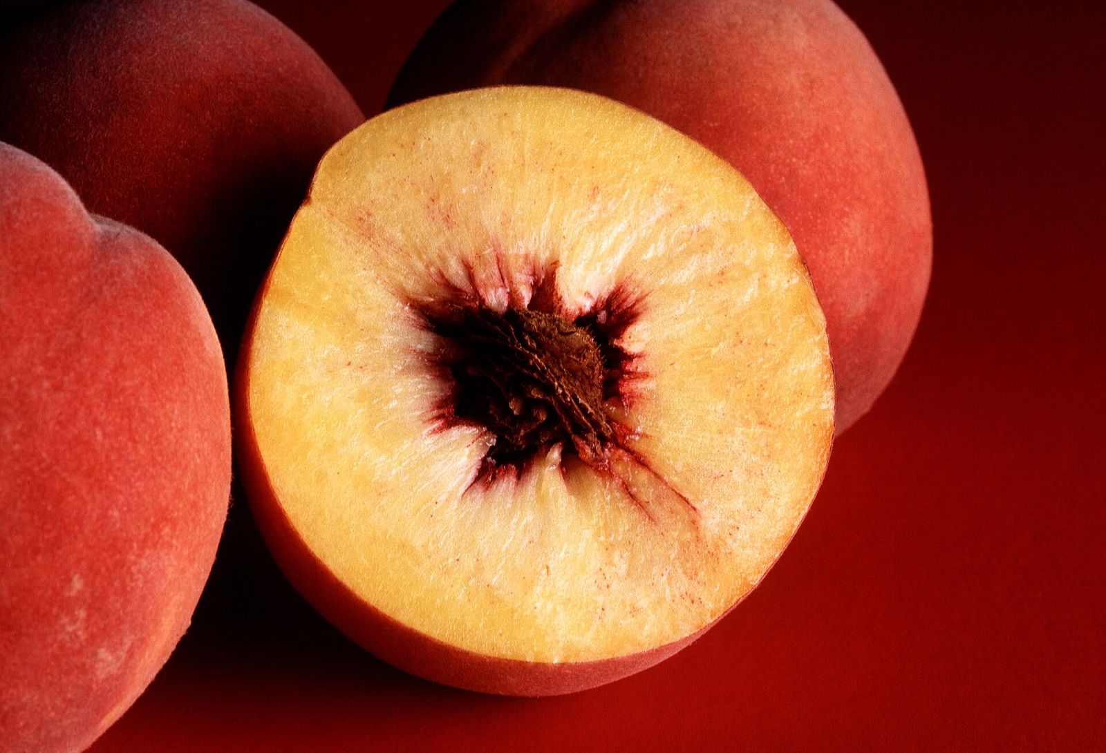 Ripe peaches, one halved